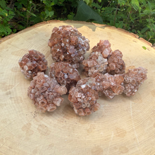 cluster of star aragonite on wooden stomp for used for meditation, balance, and energy clearing.