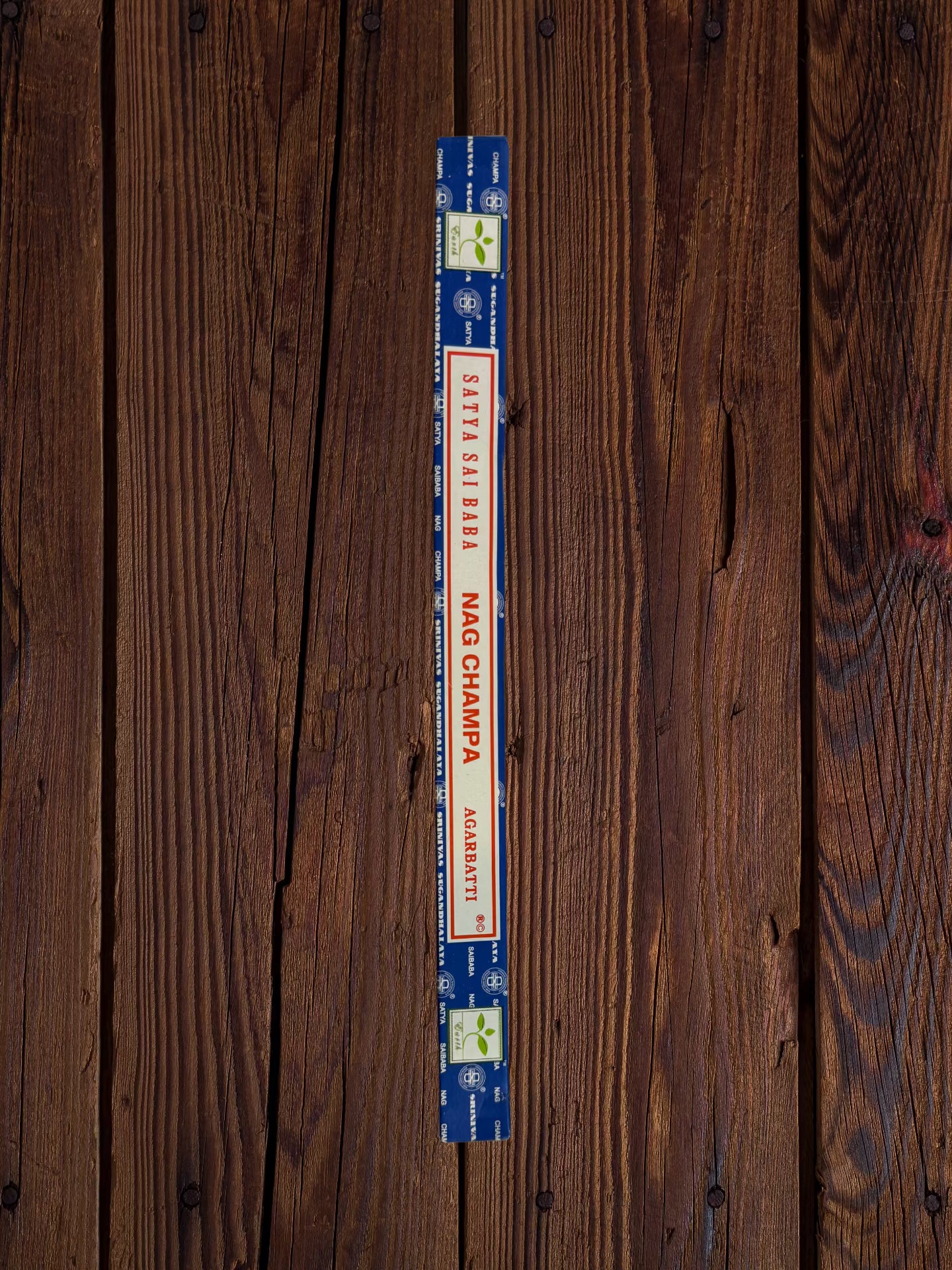 Single Satya Sai Baba Nag Champa 10g incense package on a white brick background