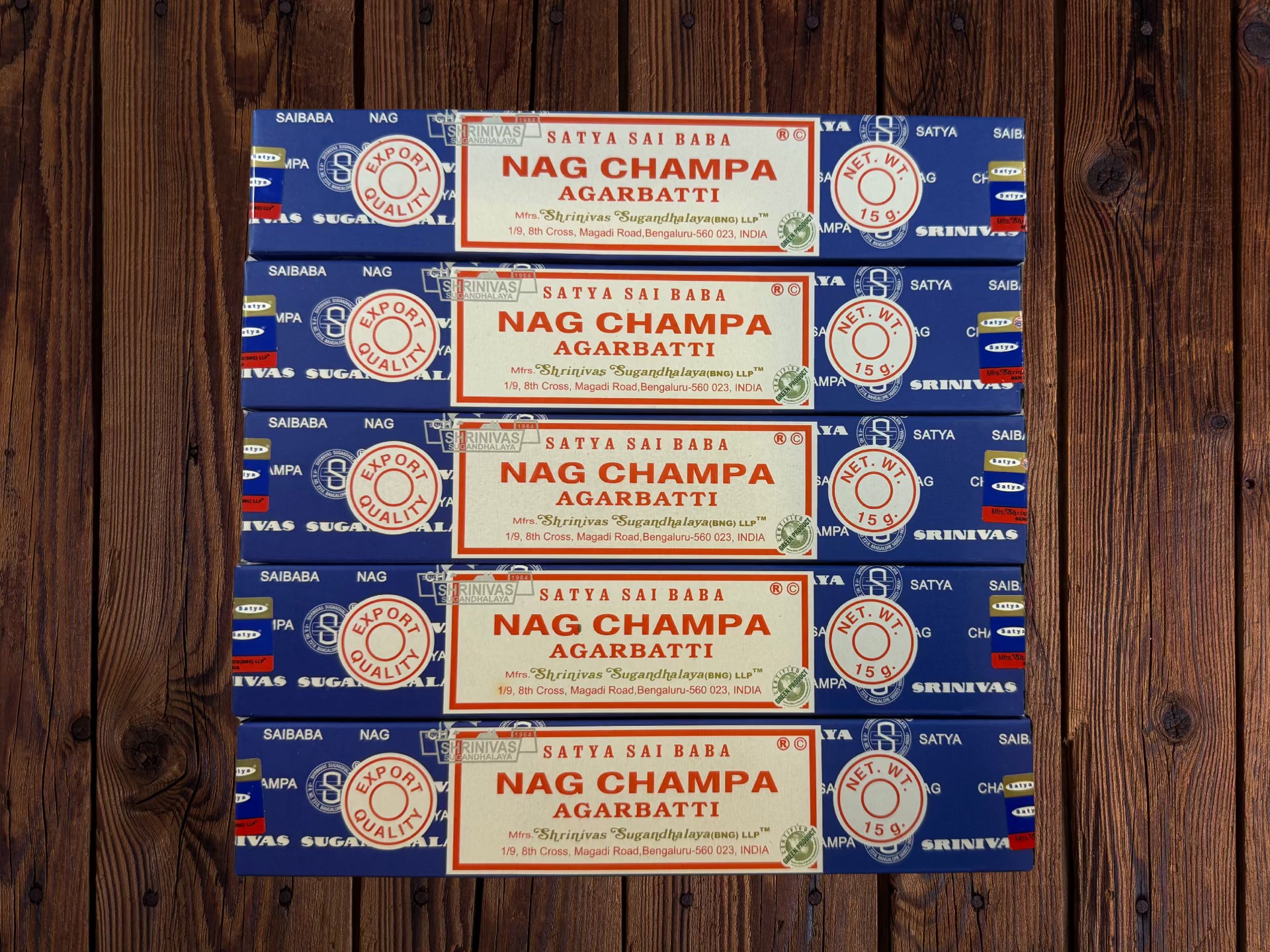 Five blue Satya Sai Baba Nag Champa incense packages on a white brick background