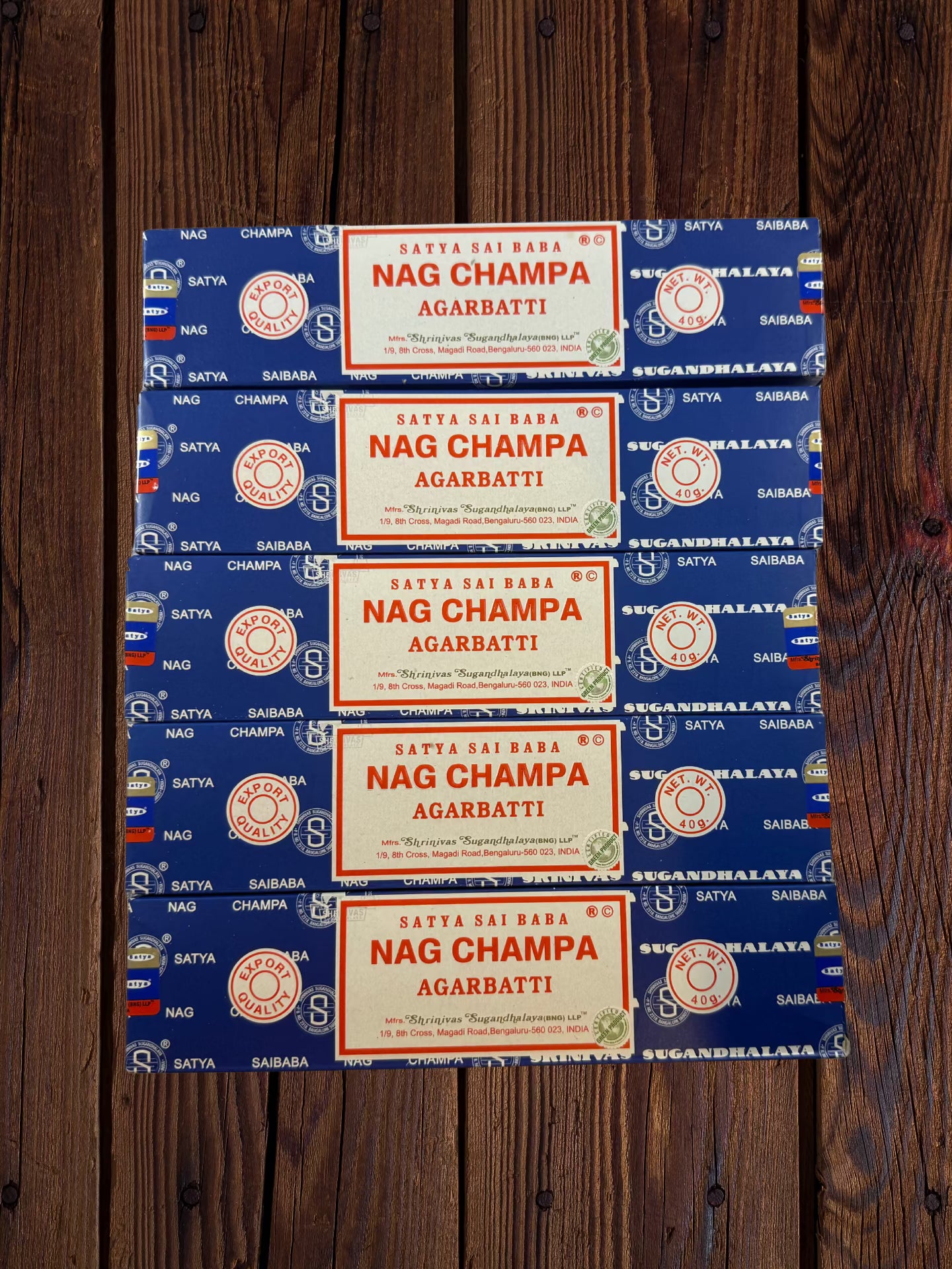 Five Satya Sai Baba Nag Champa 40g incense packages arranged on wood