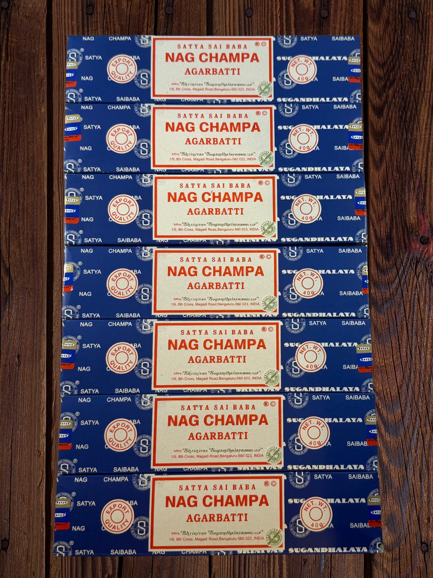 Seven Satya Sai Baba Nag Champa 40g incense packages arranged on wood