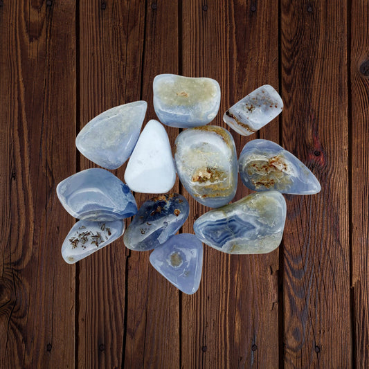 Polished Blue Lace Agate tumble stones on a white background – calming crystal for peace and communication