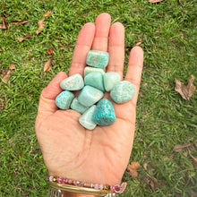 Hand holding Amazonite tumble stones – natural gemstone for relaxation and positive energy