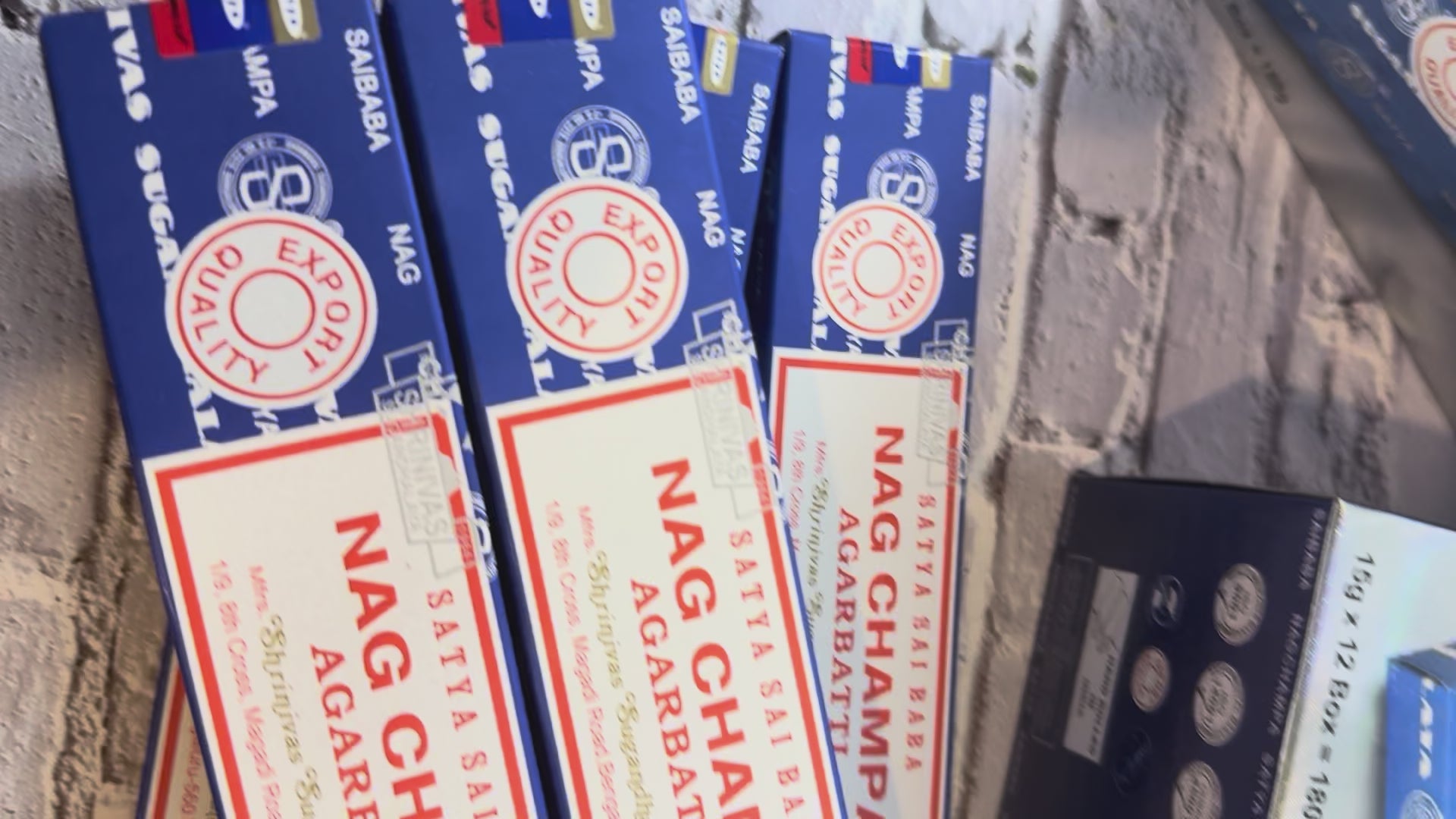 Open display box of Satya Sai Baba Nag Champa incense beside a closed box and single package