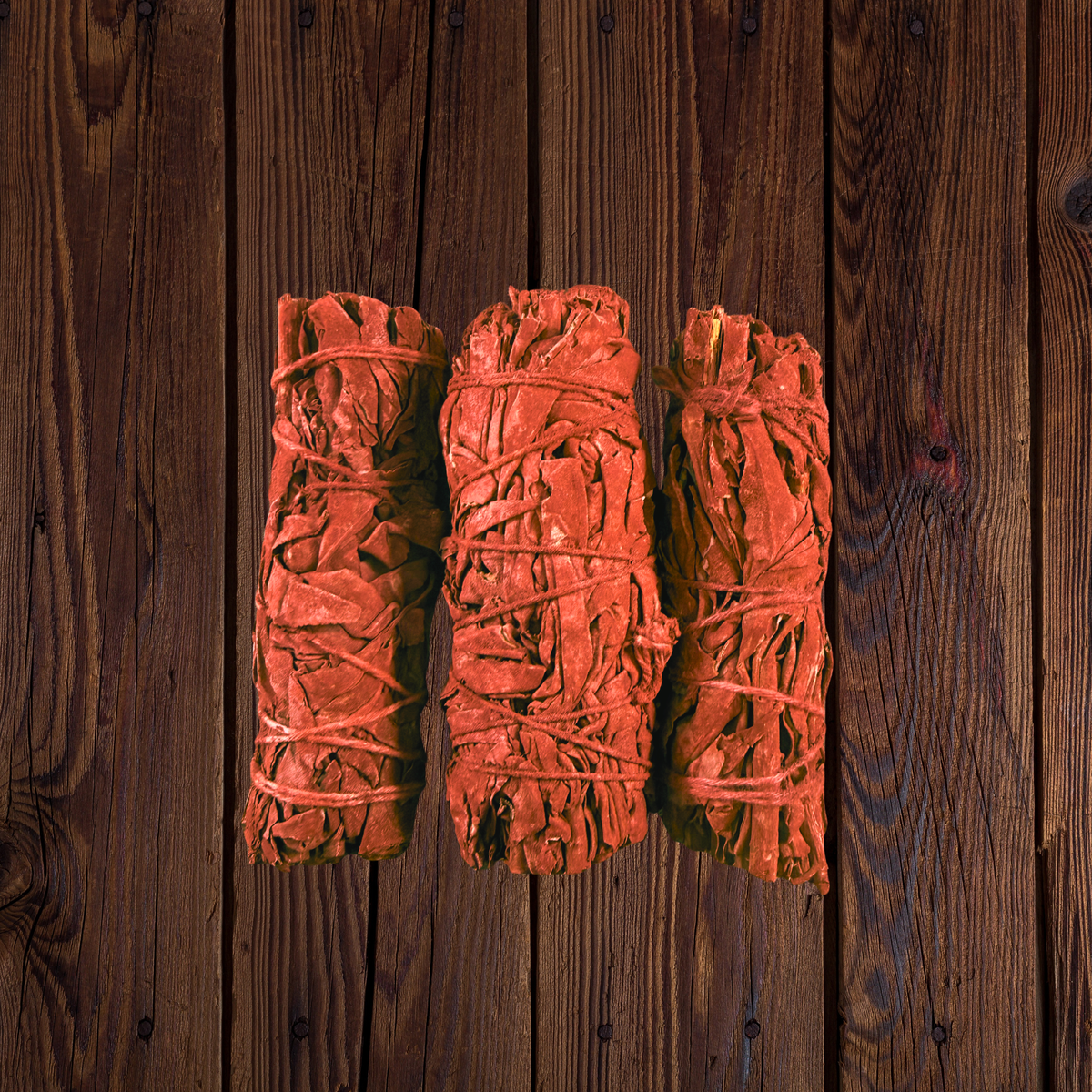  Dragon’s Blood white sage smudge three sticks arranged side by side on dark wood